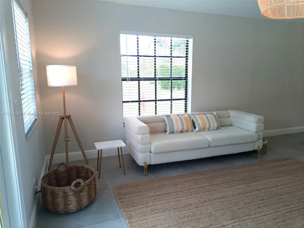 a living room with furniture and a potted plant