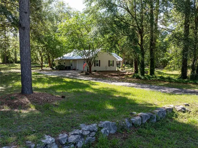 a spacious bathroom with a granite countertop sink mirror and