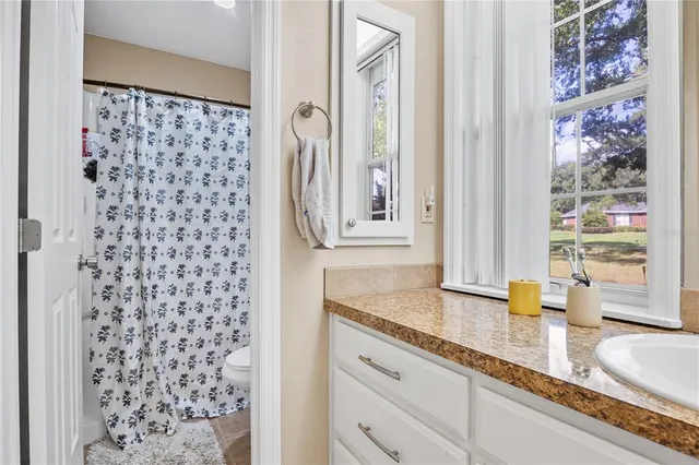 a bedroom with a bed and a flat tv screen on dresser