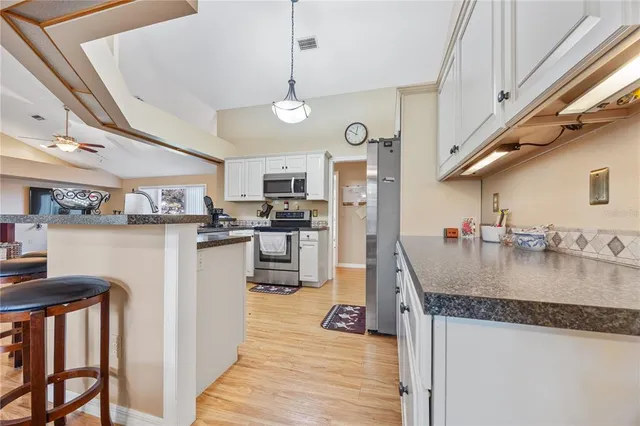 a kitchen with lots of counter top space and stainless steel appliances