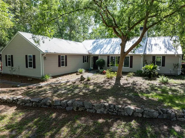 a backyard of a house with yard and outdoor seating