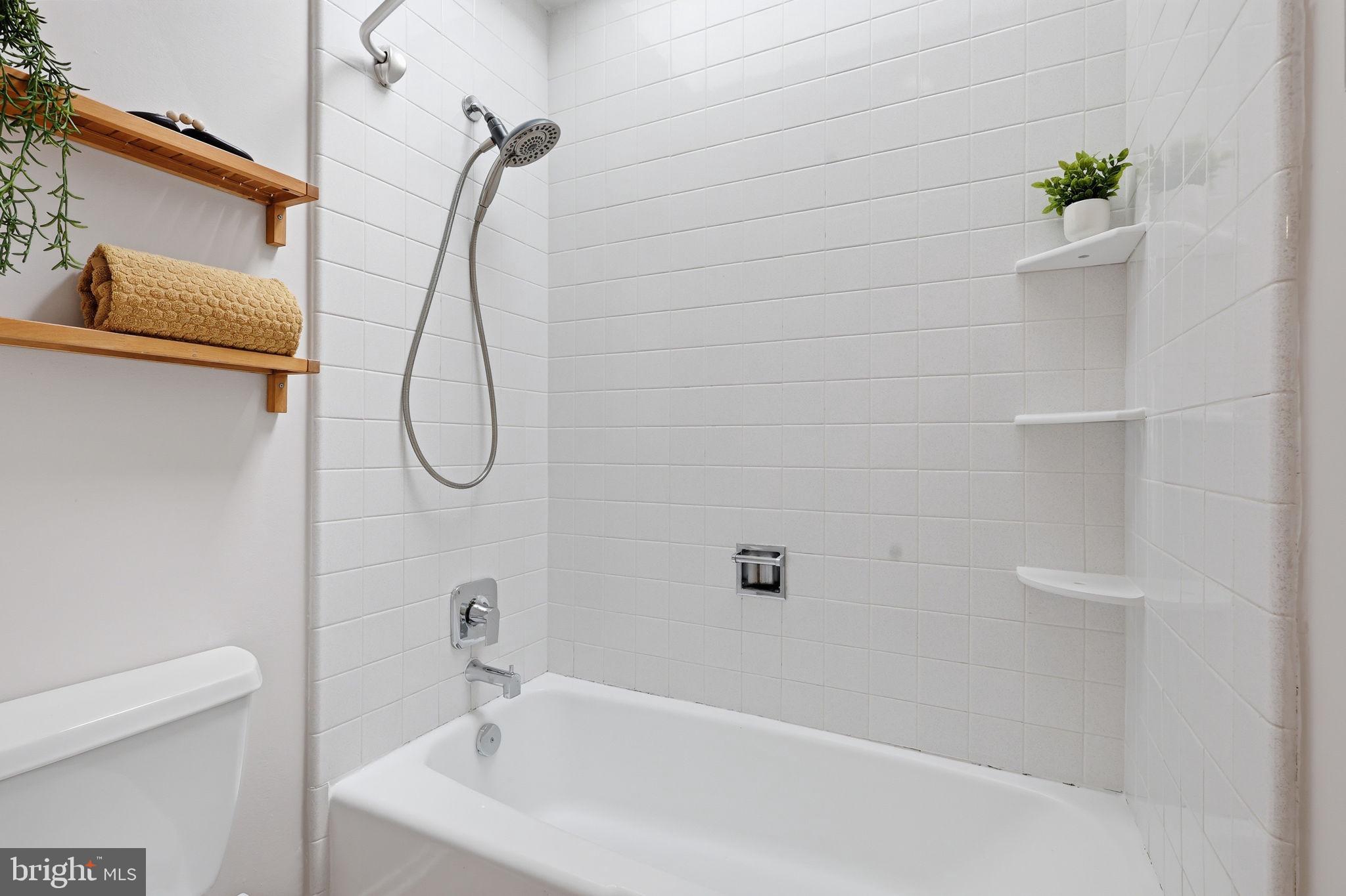 11510 Maple Ridge Road Reston, VA 20190 - Photo 31 of 43 a bathroom with a bath tub with a shower