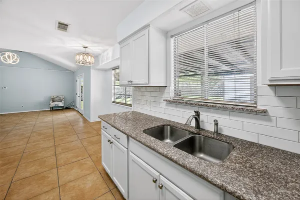 a kitchen with a sink and cabinets