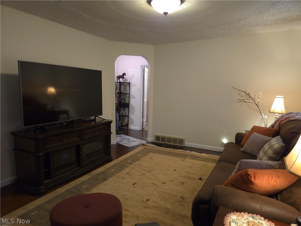 3186 Styx Hill Road Medina, OH 44256 - Photo 4 of 17 Living room featuring a textured ceiling and dark hardwood wood floors