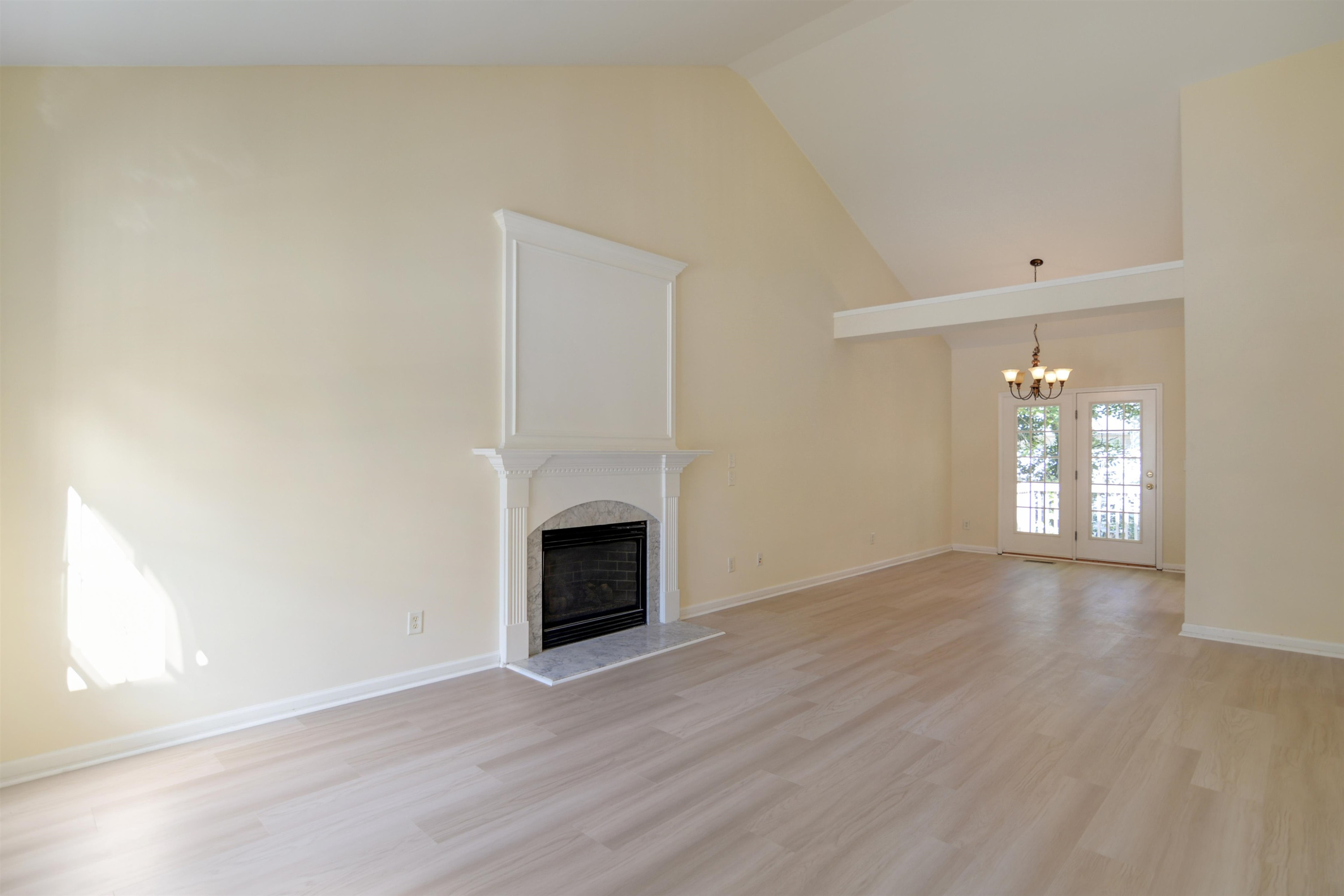 2708 Upper Dry Falls Court Raleigh, NC 27603 - Photo 2 of 16 a view of an empty room with wooden floor and a window
