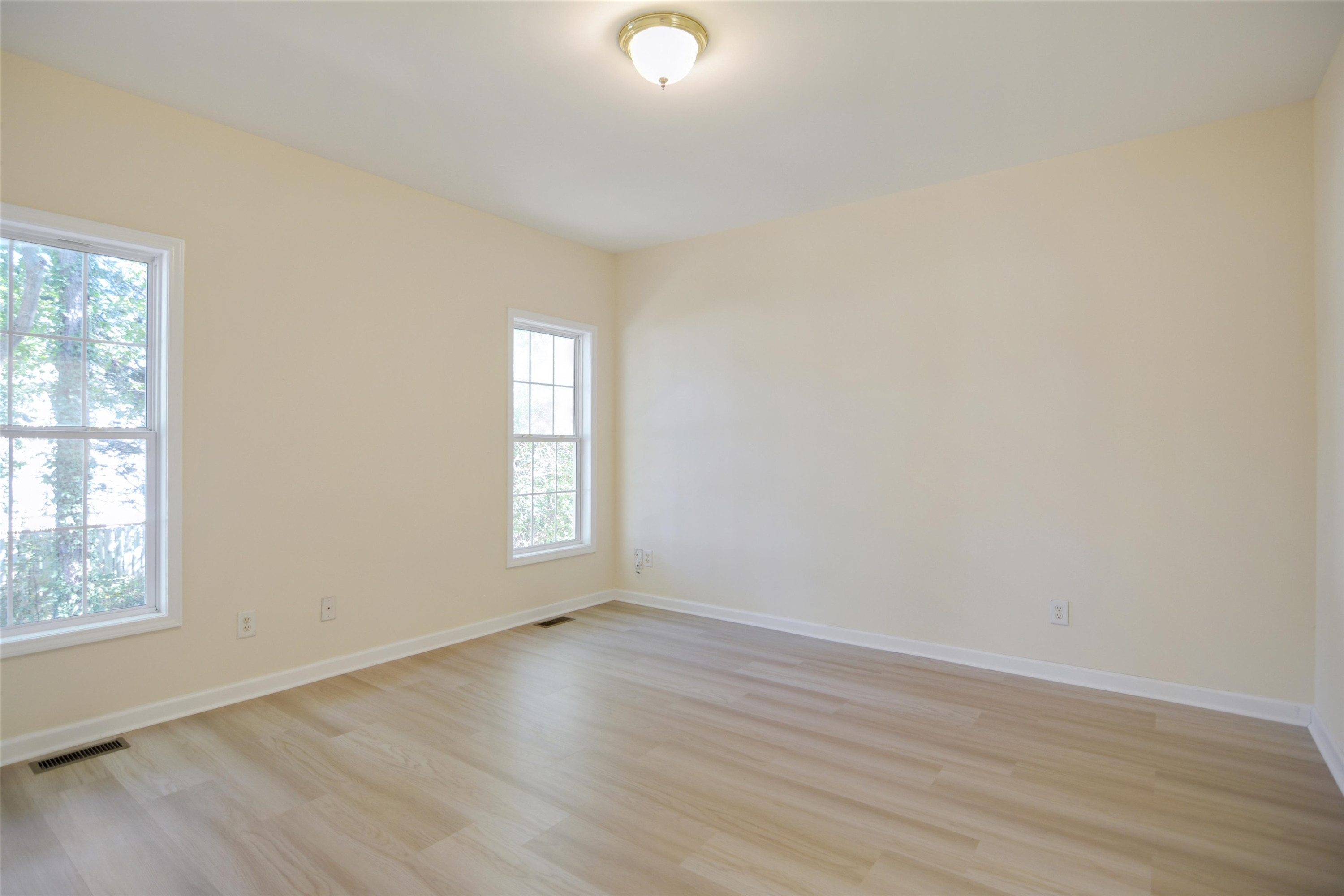 2708 Upper Dry Falls Court Raleigh, NC 27603 - Photo 8 of 16 an empty room with wooden floor and windows