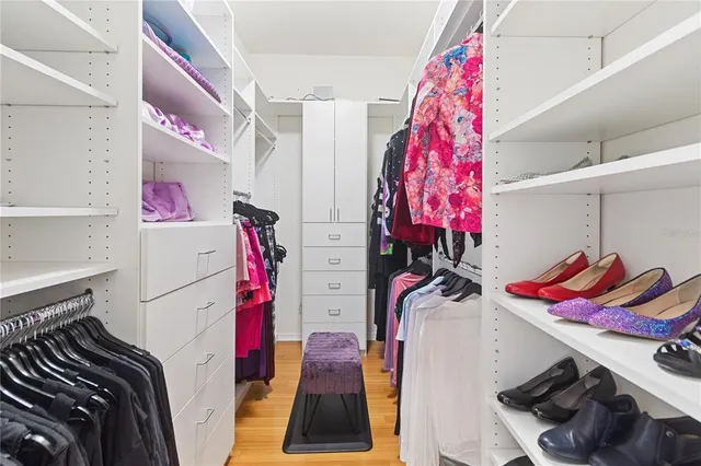 a bathroom with a granite countertop sink a mirror a bathtub and toilet