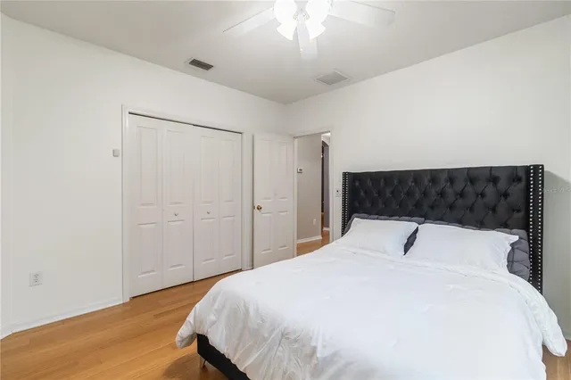a bathroom with a granite countertop sink a toilet and a mirror