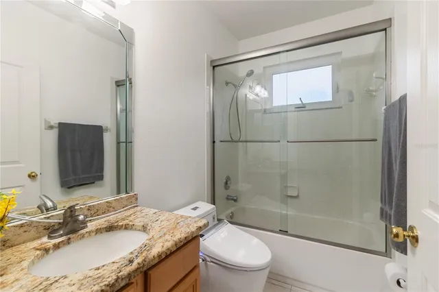 a view of empty room with wooden floor and fireplace