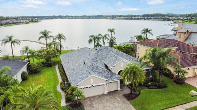 a front view of a house with a garden and trees