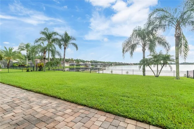 a view of a house with a big yard and sitting area