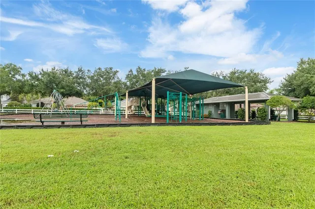 a view of a house with a yard and sitting area