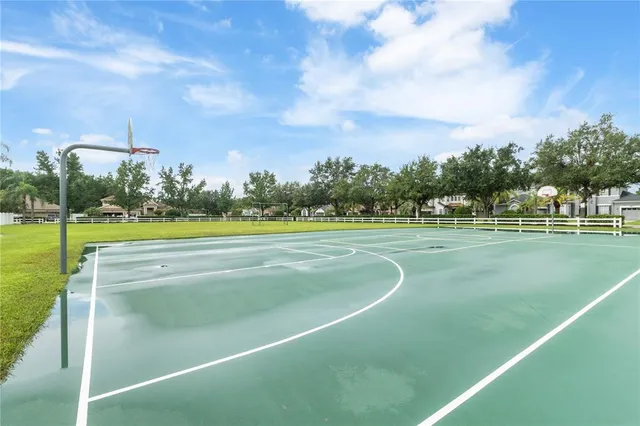 an aerial view of a house with a yard and lake view