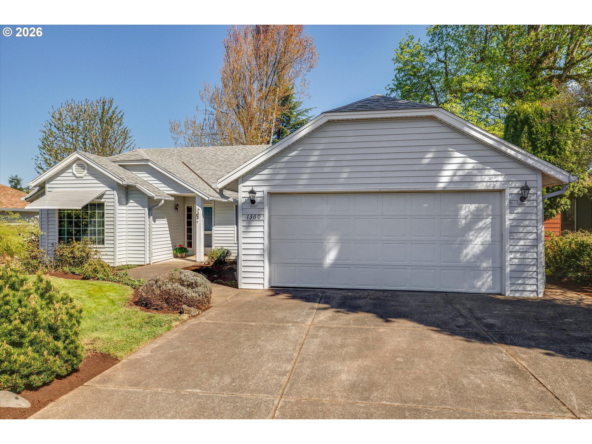 1360 North Locust Street Canby, OR 97013 - Photo 1 of 36 a front view of a house with a yard and garage