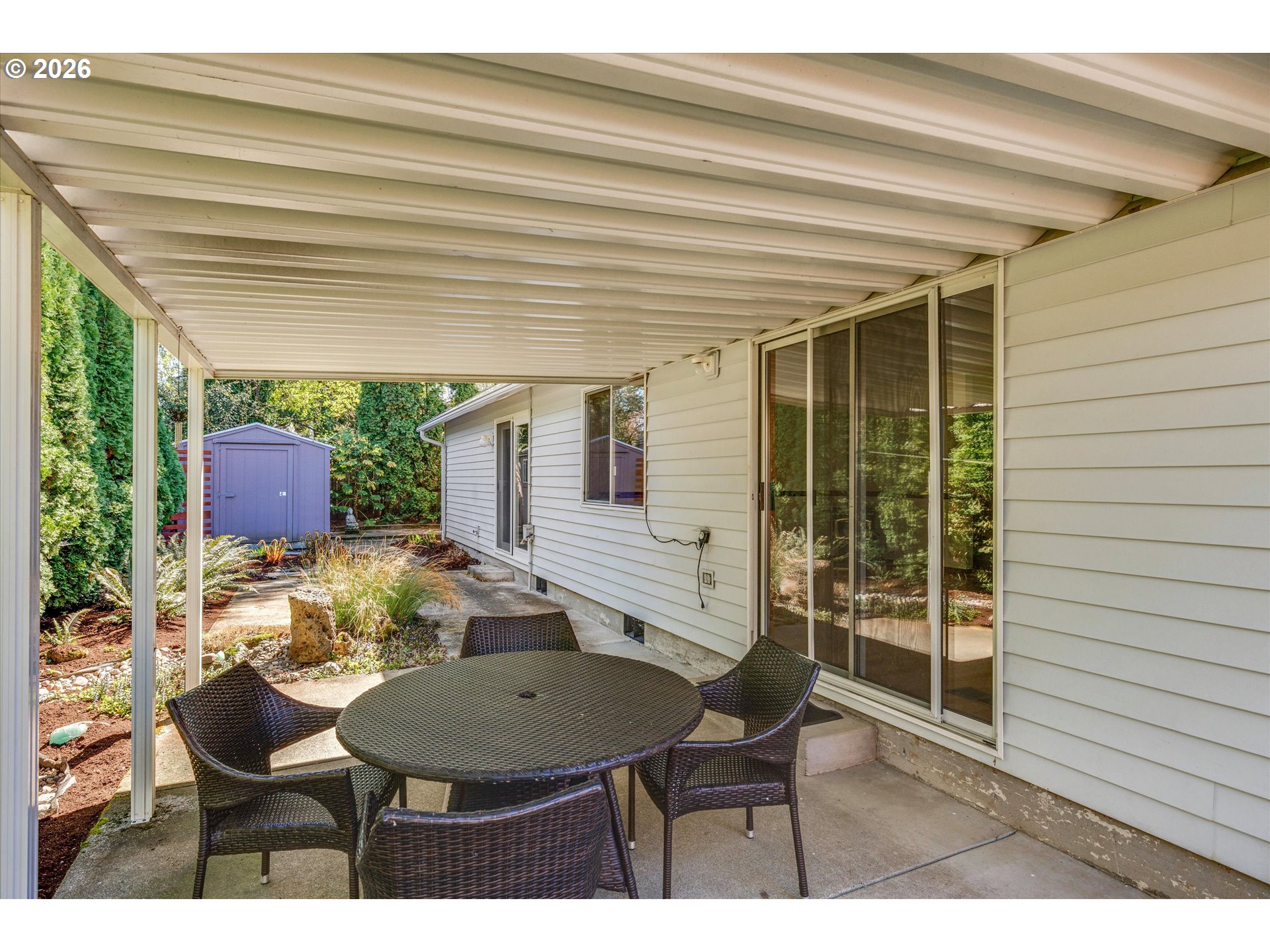 1360 North Locust Street Canby, OR 97013 - Photo 27 of 36 a view of a patio with table and chairs with wooden floor and plants