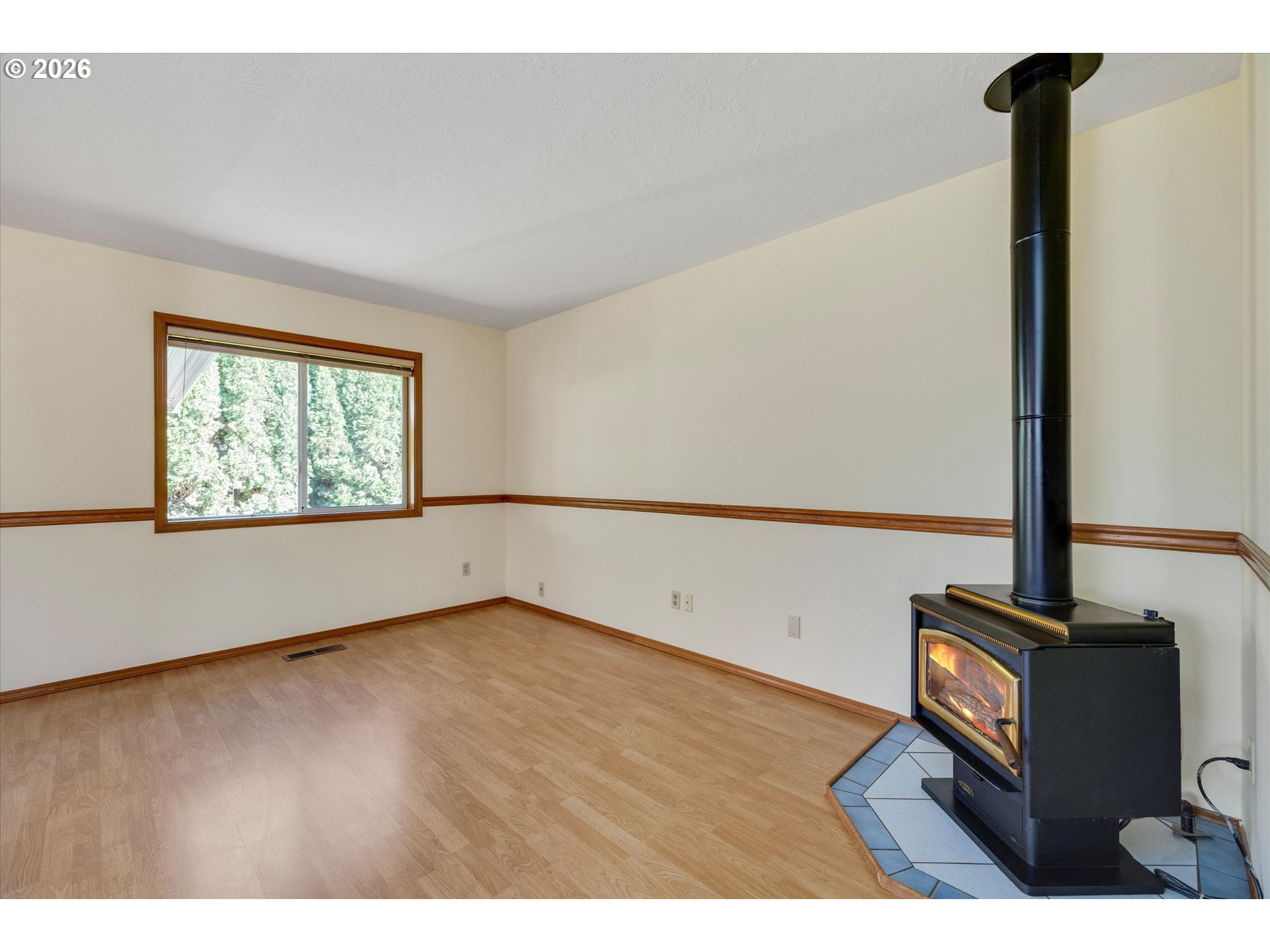 1360 North Locust Street Canby, OR 97013 - Photo 9 of 36 a view of an empty room with wooden floor