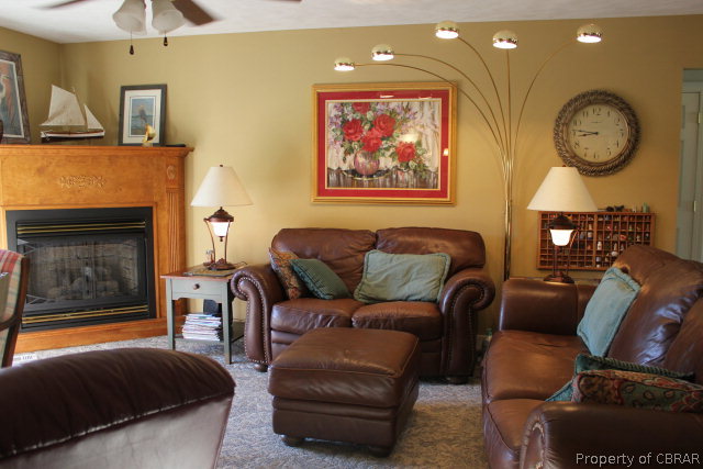 882 Pine Hall Road Mathews, VA 23109 - Photo 18 of 26 a living room with furniture a fireplace and a flat screen tv
