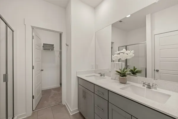 a bathroom with a double vanity sink and mirror