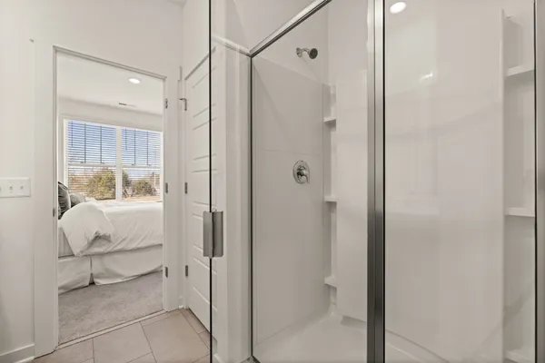 a bathroom with a glass shower door and a sink