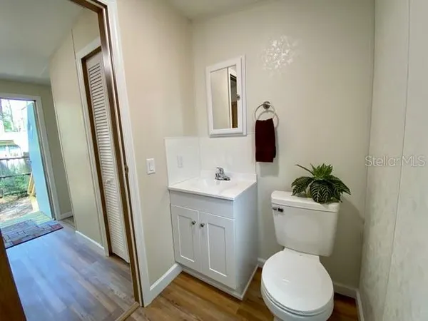a white toilet sitting next to a bathroom sink