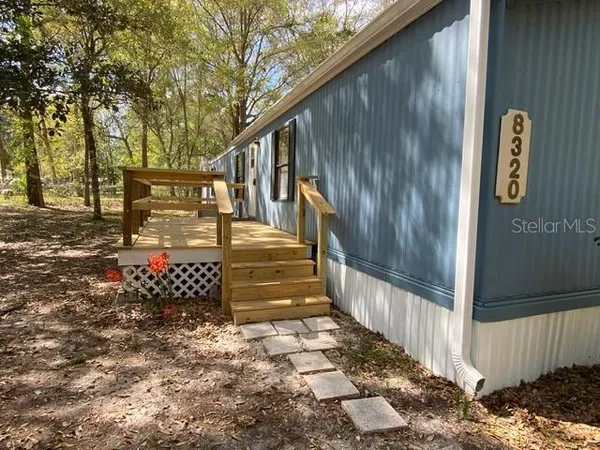 a backyard of a house with table and chairs