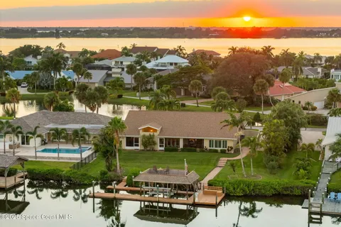 an aerial view of a house with a swimming pool yard and lake view