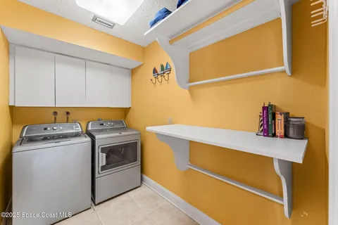 a front view of a house with a garden and lake view