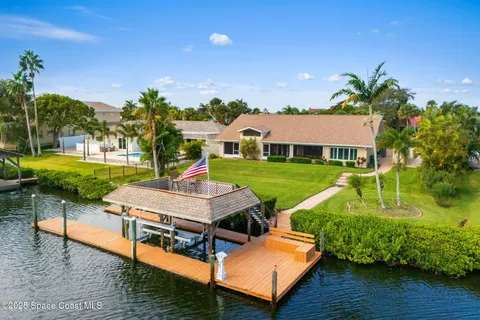an aerial view of a house with a swimming pool