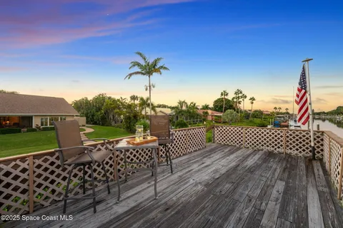 a view of a swimming pool with a patio and a yard