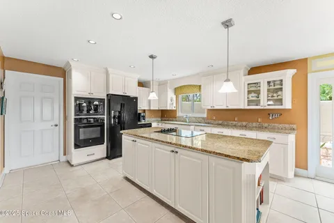 a living room with furniture floor to ceiling window and wooden floor