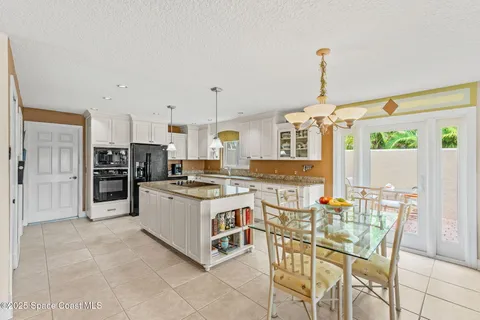 a living room with patio furniture and garden view