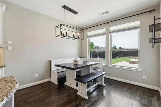 a work room with wooden floor and windows