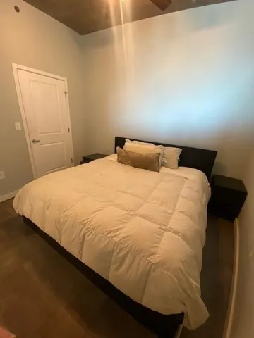 a large bed sitting in a bedroom next to a window