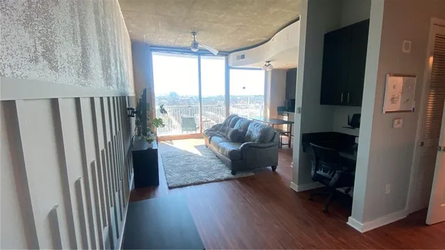 a living room with furniture and a floor to ceiling window