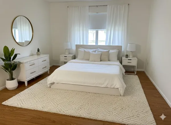 a spacious bedroom with a bed and a potted plant