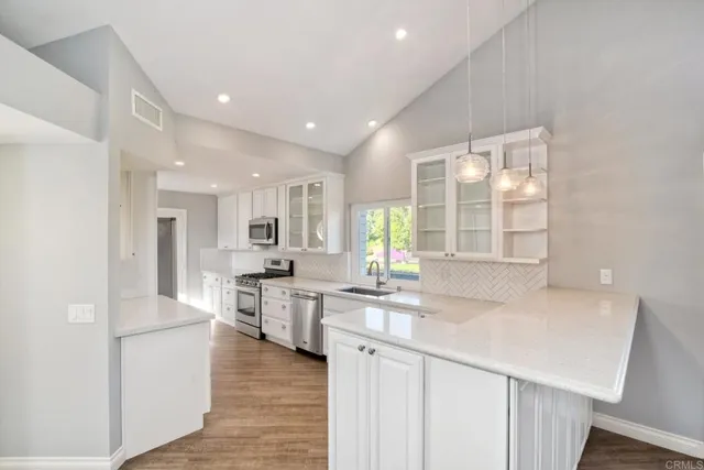 a kitchen with a stove a sink and a refrigerator