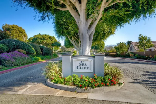 a sign that is sitting in front of flowers