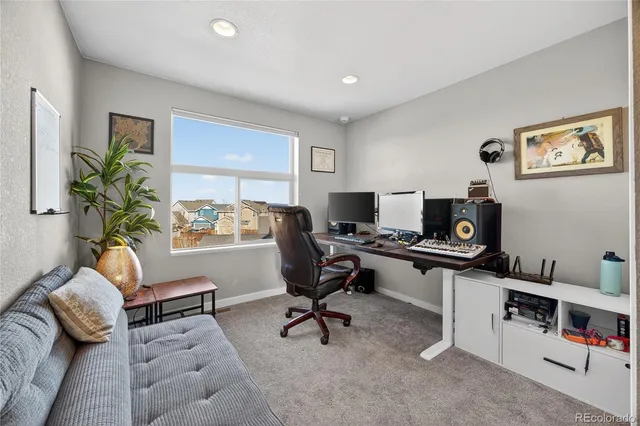 a view of a workspace with a window and couch