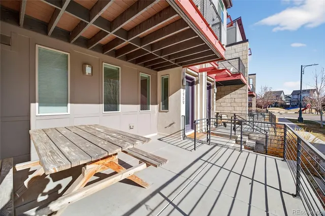 a view of a patio with dining table and chairs with wooden floor