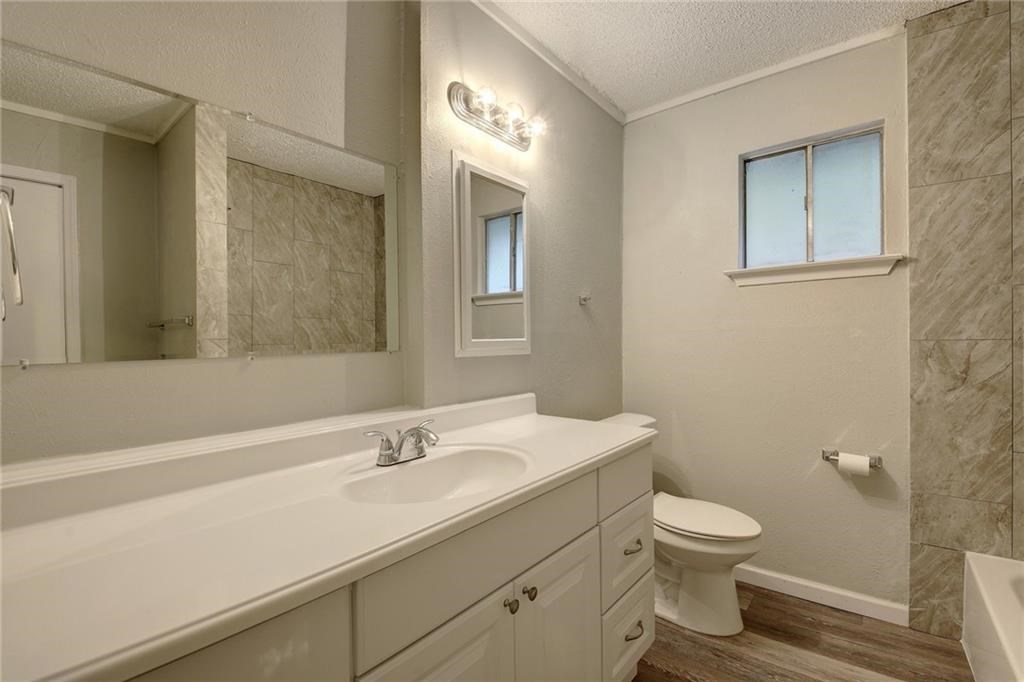 2311 Teri Road, Unit B Austin, TX 78744 - Photo 14 of 25 a bathroom with a toilet sink and mirror