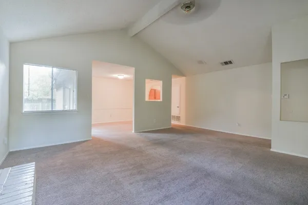 a view of an empty room with windows