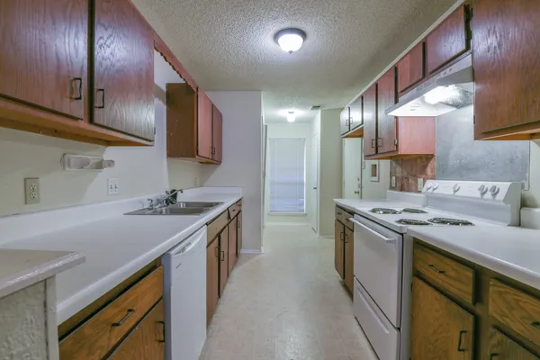 a kitchen with a sink stove and cabinets