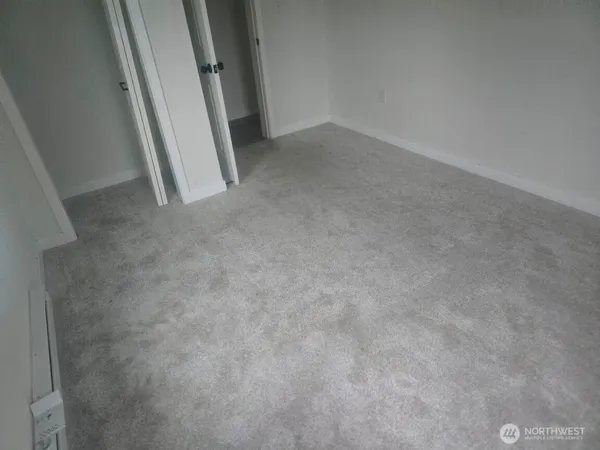 a view of an empty room and a window