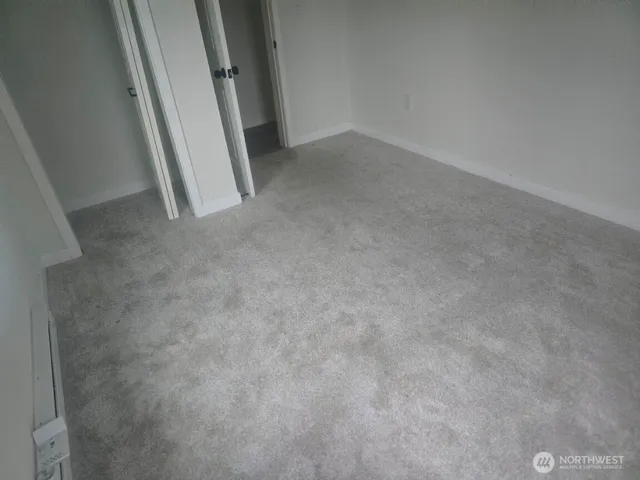 a view of an empty room and a window