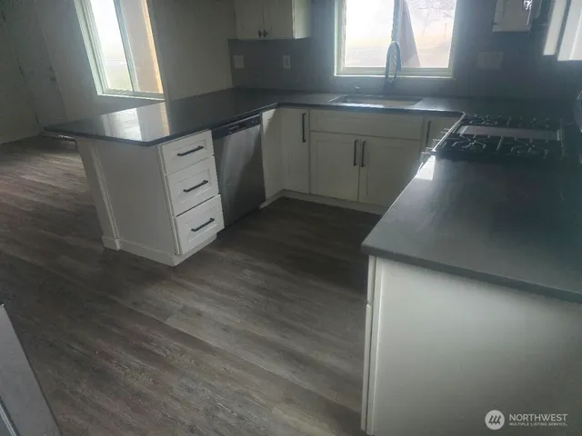 a kitchen with a sink and cabinets