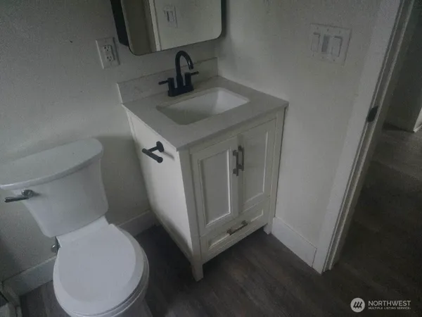 a bathroom with a toilet sink and mirror