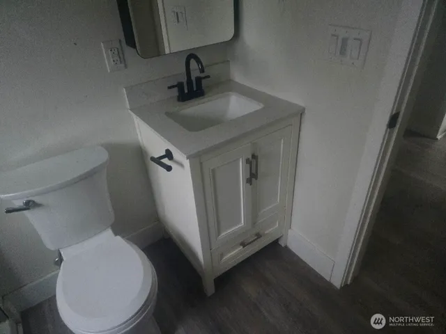 a bathroom with a toilet sink and mirror