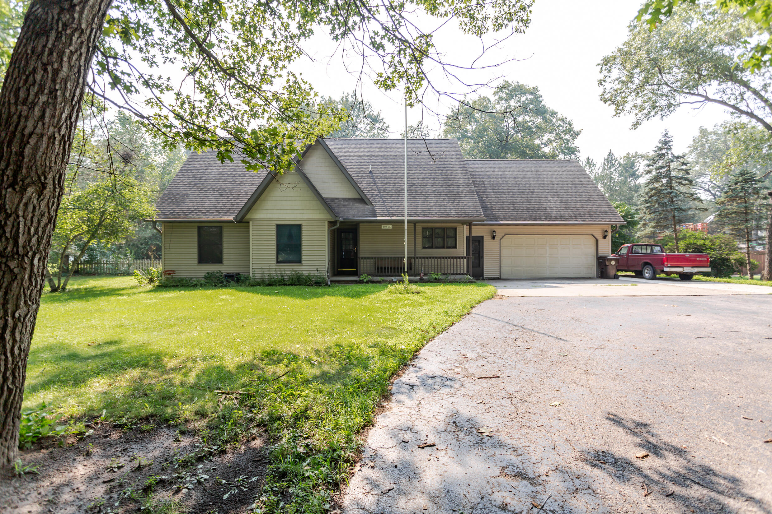 a house that has a tree in front of it