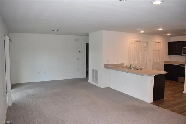 a large white kitchen with a sink