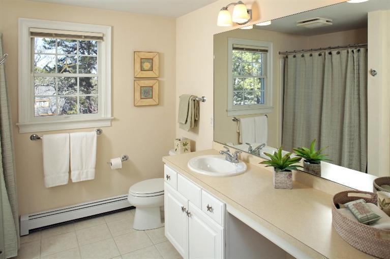 50 Woods Neck Road Orleans, MA 02653 - Photo 15 of 22 a bathroom with a granite countertop sink mirror vanity and toilet